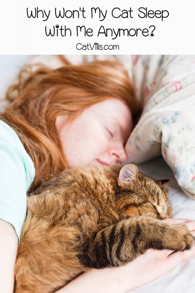 Brown cat sleeping next to red-haired woman with text "Why Won't My Cat Sleep With Me Anymore"